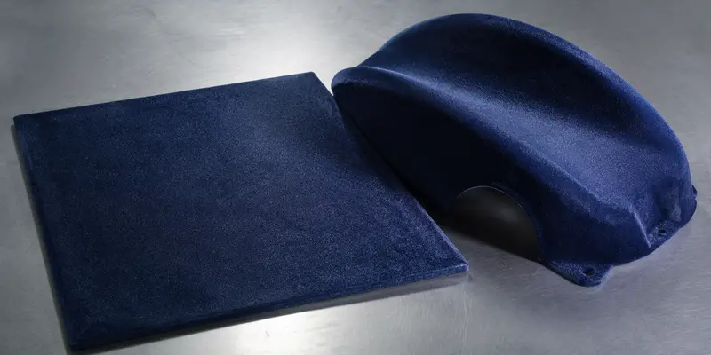 Colored flocking powder appearance on flat and curved flocked surfaces