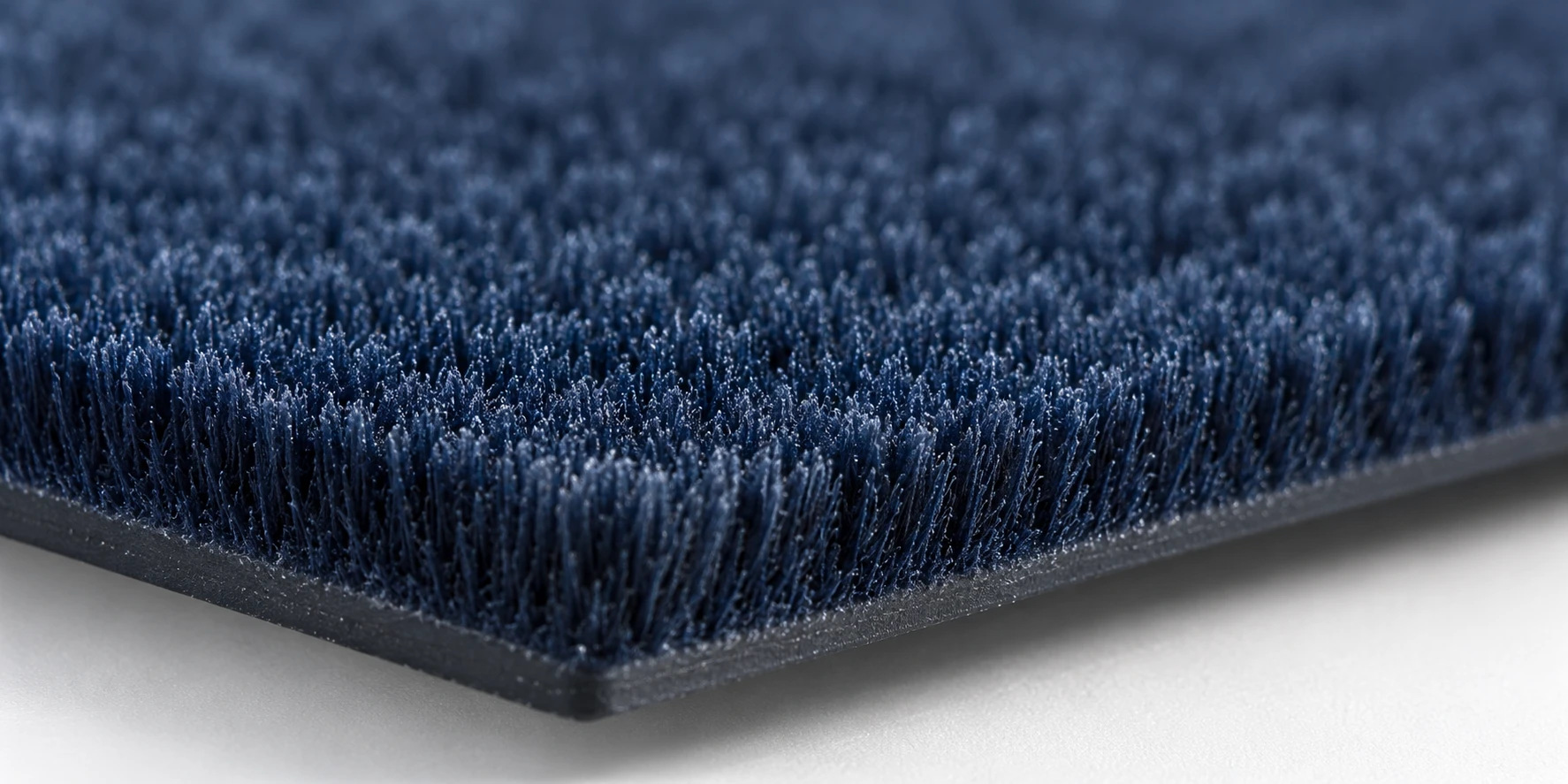 Close-up view of electrostatic flocking with dense upright flock fibers creating a soft velvet-like surface texture. Close-up view of electrostatic flocking with dense upright flock fibers creating a soft velvet-like surface texture.